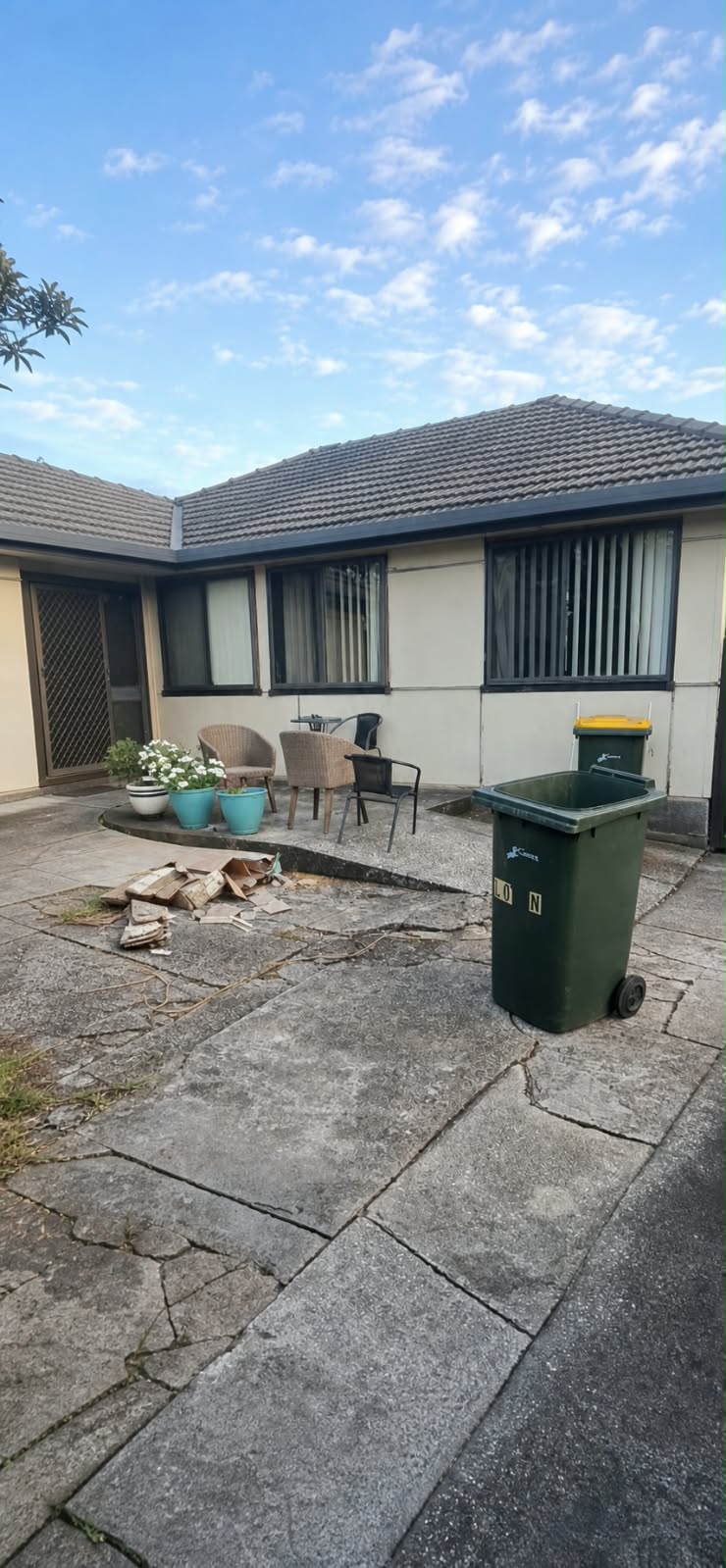 Original painted walls and cracked paving before cladding
